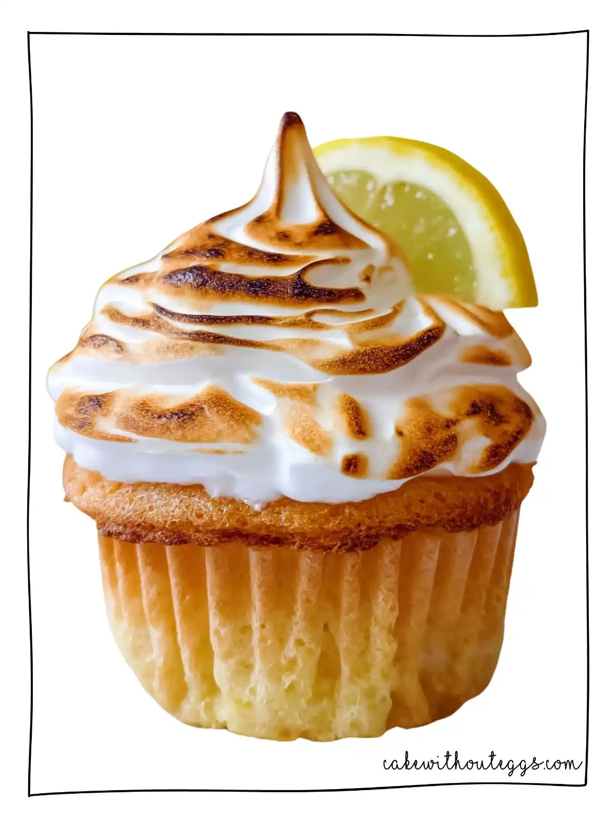 Close-Up of Eggless Lemon Meringue Cupcake with Swirled Toasted Meringue and Lemon Garnish Eggless Lemon Meringue Cupcake with toasted meringue and lemon slice