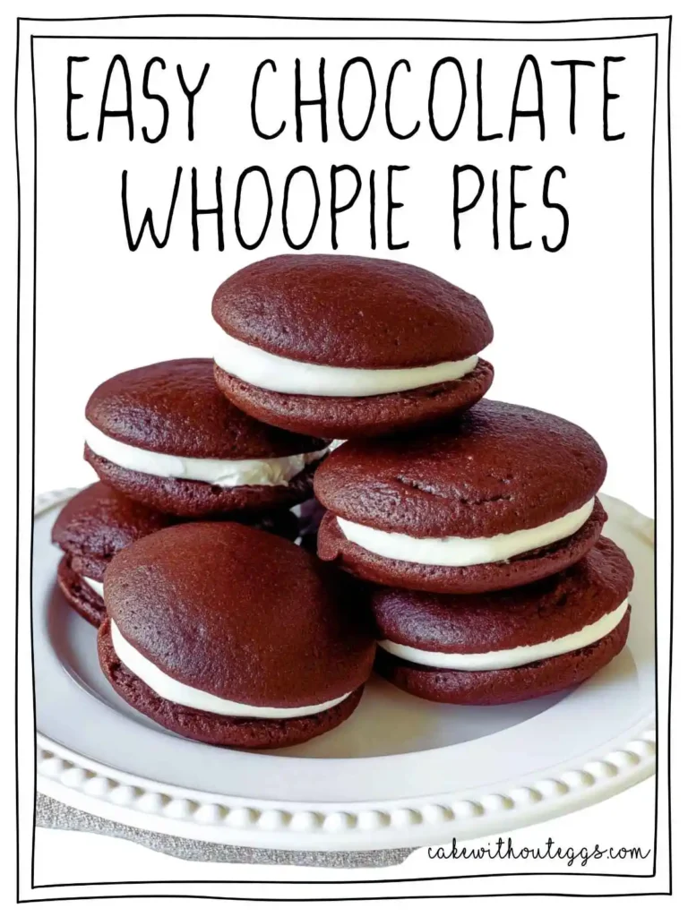 Stack of egg-free chocolate whoopie pies with creamy marshmallow filling on a white plate.