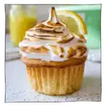 Eggless lemon meringue cupcakes topped with toasted golden meringue and filled with tangy lemon curd