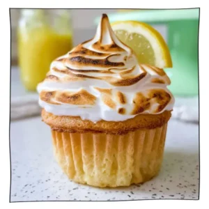 Eggless lemon meringue cupcakes topped with toasted golden meringue and filled with tangy lemon curd